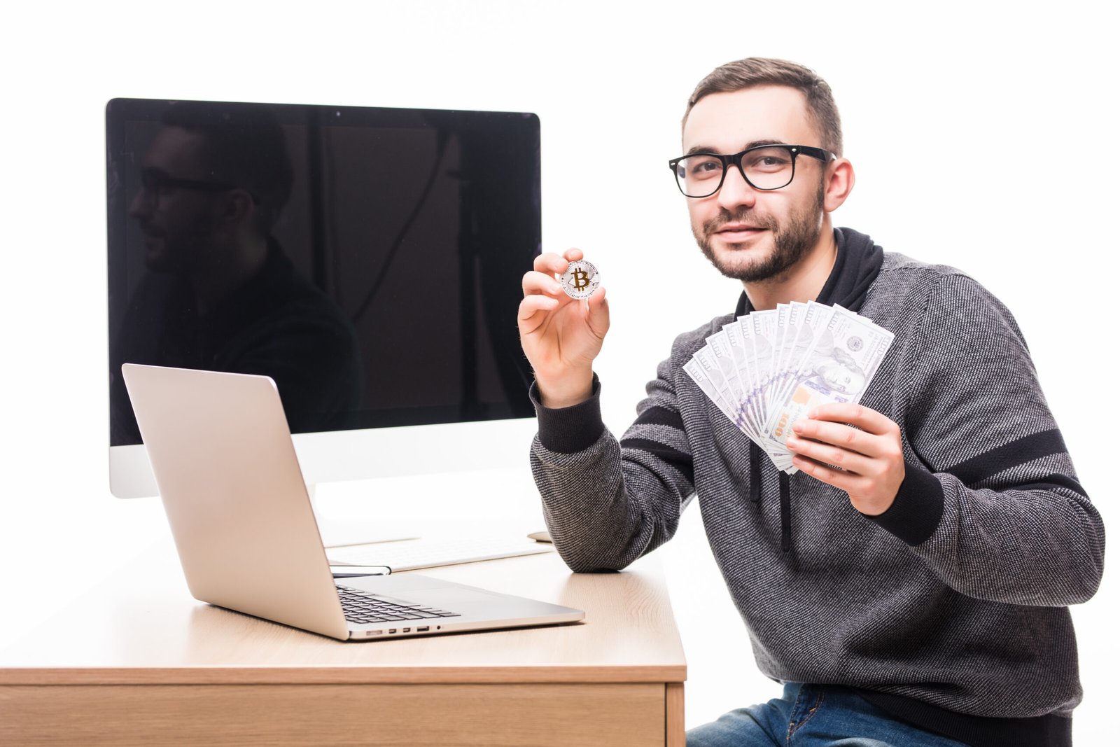 https://img.freepik.com/free-photo/handsome-bearded-man-his-working-place-with-laptop-pc-monitor-screen-back-with-bitcoin-dollars-cash-hands_231208-11135.jpg?t=st=1742717866~exp=1742721466~hmac=b00ef5b292efd98b8ee18b38cb3be31502773dcac79b9a602398cd37d34a7187&w=996