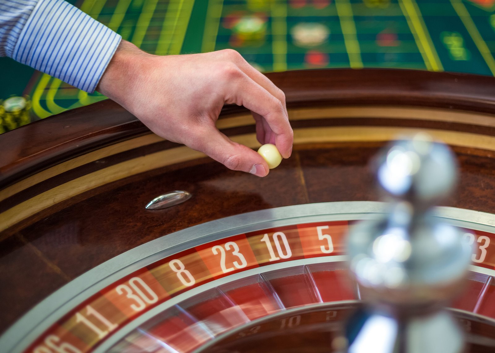 roulette-wheel-croupier-hand-with-white-ball-casino-close-up-details-1.jpg